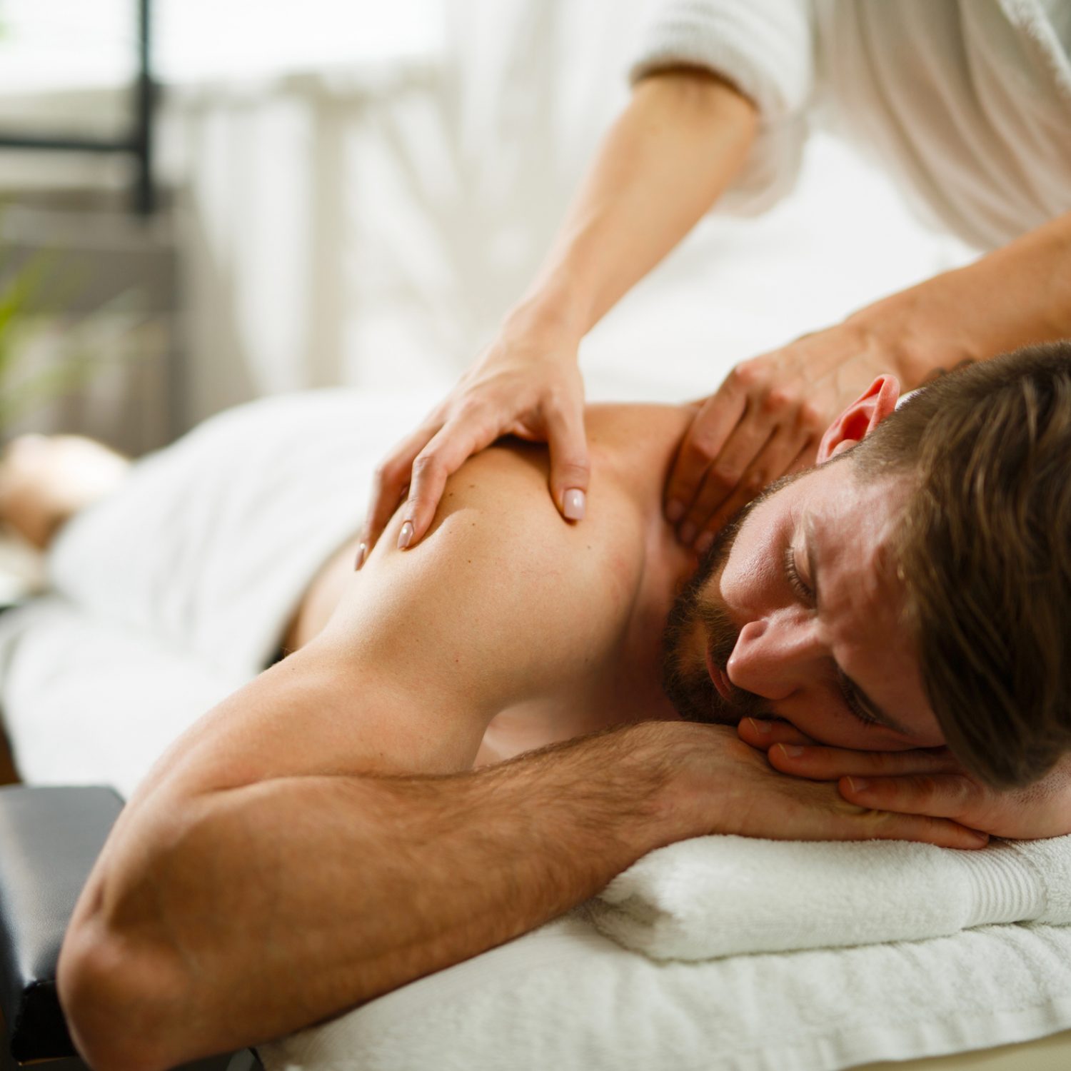 Man having back massage in the health spa. Copy space.